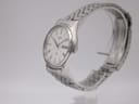 Angled side profile of the Seiko quartz dress watch, highlighting the slim round stainless steel case and polished bezel
