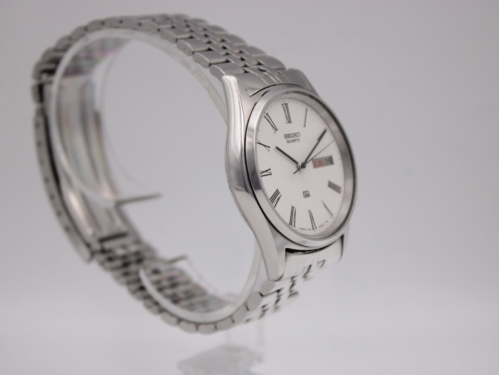 Another angled side profile of the Seiko watch, showing the elegant curve of the case and the stainless steel bracelet