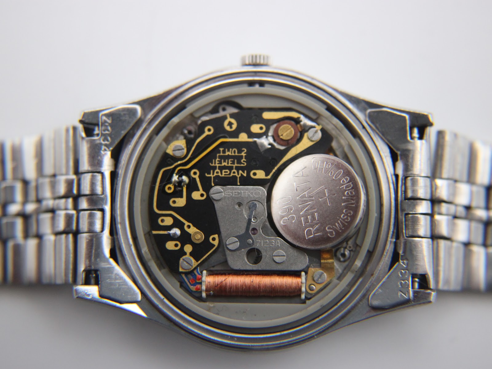 Detailed view of the Seiko 7123A quartz movement with 'TWO 2 JEWELS JAPAN' visible, and a freshly fitted Renata 390 battery