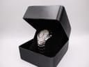 The Seiko 5M62-0AK0 watch nestled inside its open, original black Seiko box.