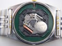 Macro shot of the Seiko 7N03C Japan quartz movement with a Renata battery inside the open case.