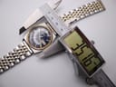 Digital caliper measuring the case diameter of the Seiko watch, displaying a precise 35.16mm.