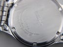 Rear view of the Seiko watch revealing the stainless steel case back with model and serial numbers.