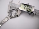 Digital caliper measuring the Seiko watch case diameter, displaying 41.28mm.