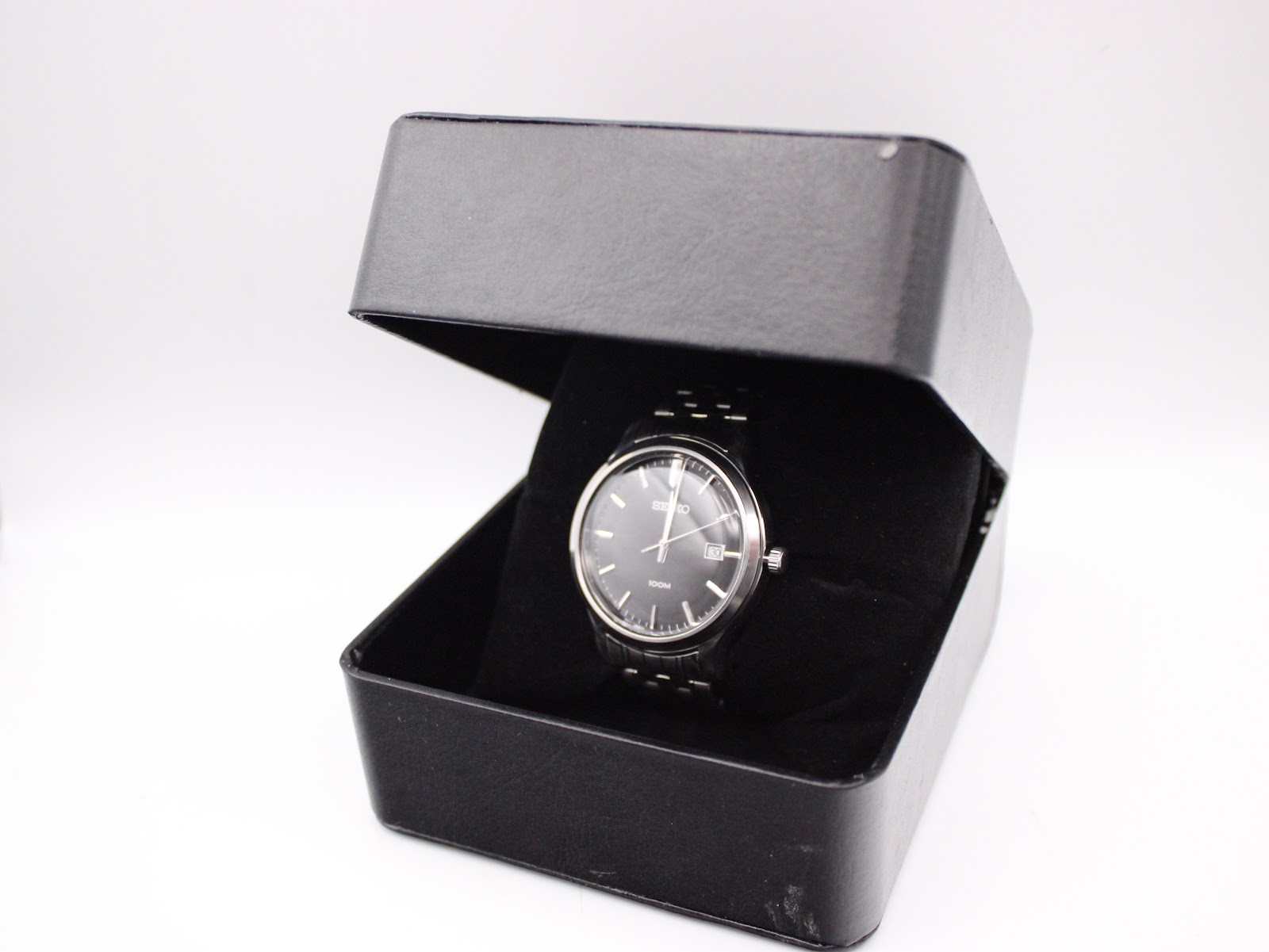 The Seiko watch presented in an open black display box.