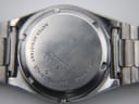 Close-up view of the watch case back showing "SEIKO WATER RESISTANT STAINLESS STEEL 7546-8200" engravings and serial number.