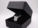 The vintage Seiko watch positioned on a cushion inside an open black presentation box, viewed from an angle.