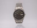 Front face of Seiko 7N43-9069 titanium watch with dark grey dial and day-date display.