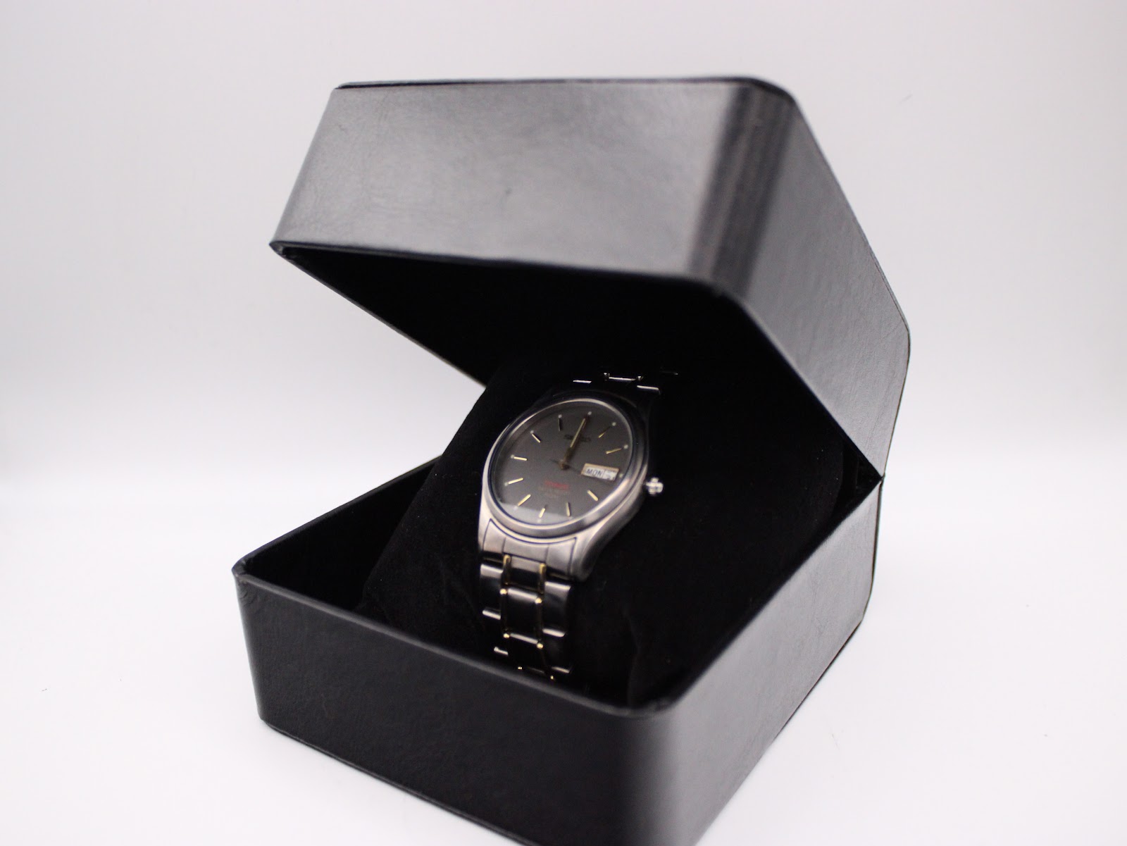 The Seiko watch displayed inside a black presentation box.