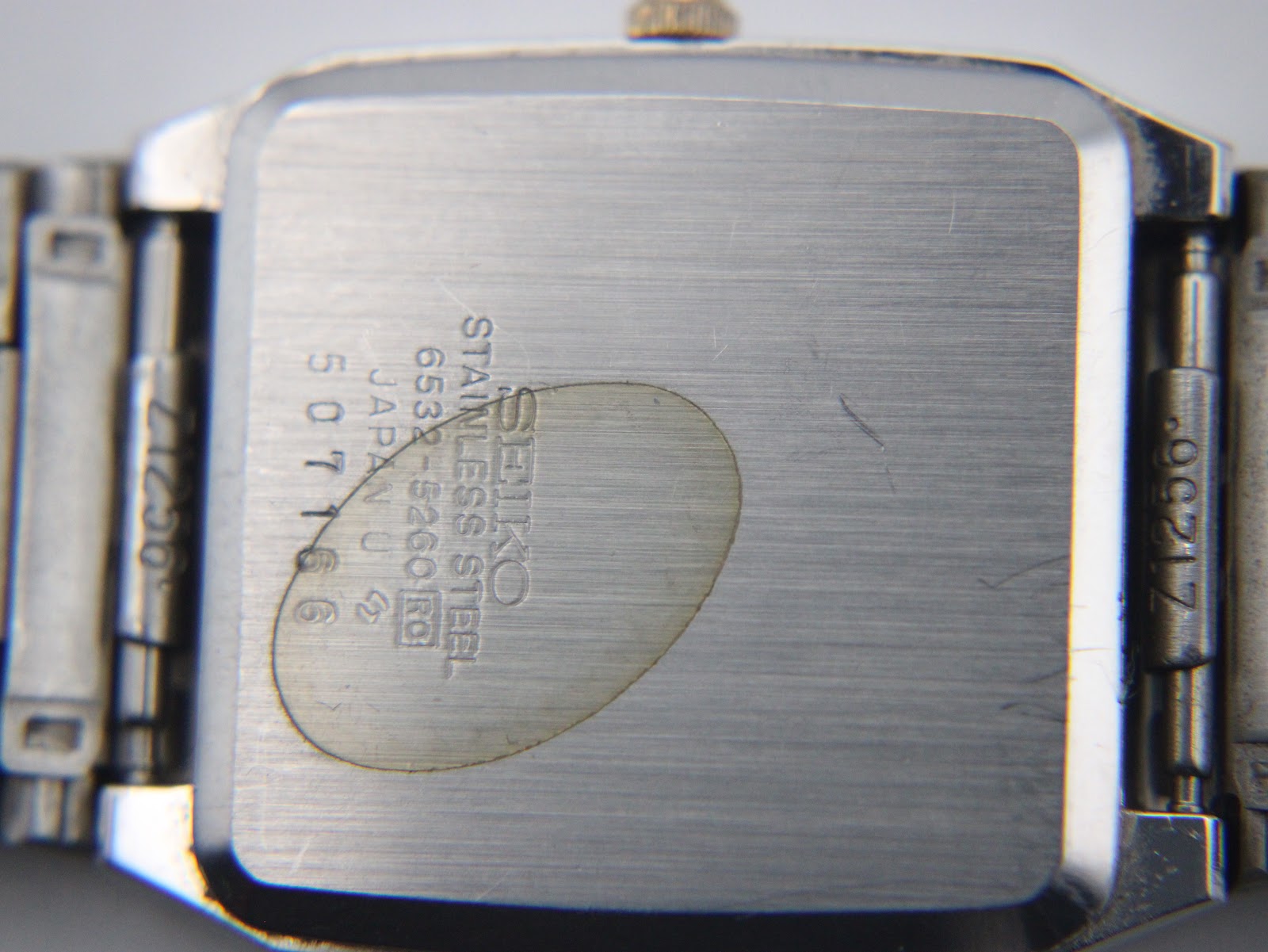 Close-up of the stainless steel case back of the Seiko 6532-5260 watch, showing model and serial.