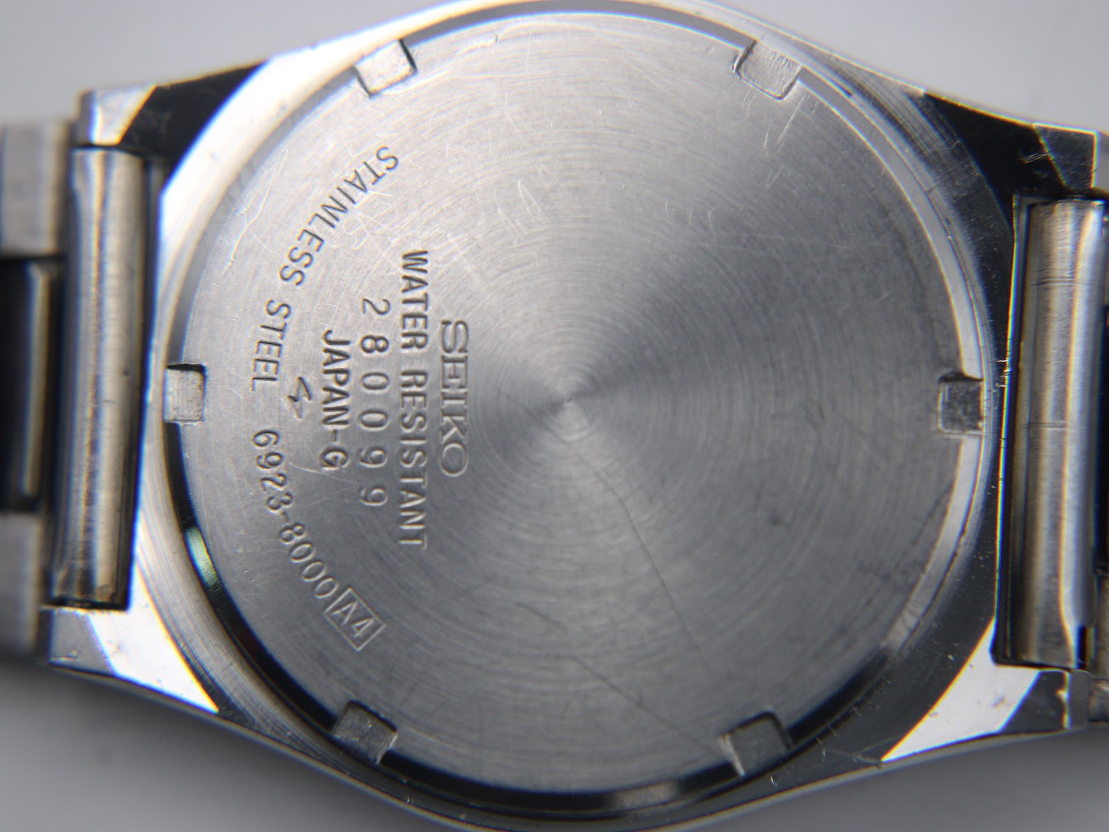 Rear view of the Seiko 6923-8000 stainless steel case back with model number '6923-8000' and 'water resistant' engraving.