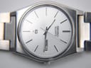 Detailed close-up of the Seiko 6923-8000's silver sunburst dial with day-date display and 'SEIKO QUARTZ' text at 12 o'clock.