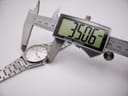 Digital caliper measuring the case diameter of the Seiko 6923-8000, displaying a precise 35.06mm.