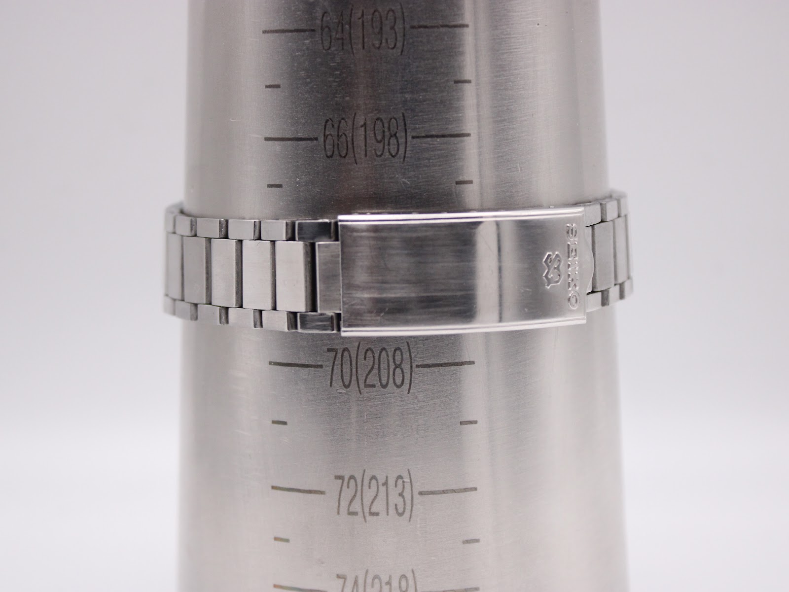 Close-up of the integrated stainless steel bracelet clasp, displaying the signed Seiko logo, on a wrist sizing gauge indicating 200.5mm / 20.05cm.