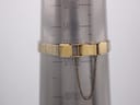 The gold-tone mesh bracelet with its safety chain wrapped around a wrist sizing gauge, indicating a maximum wrist fit of 172mm.