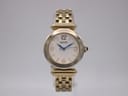 Front face of a Seiko gold-tone quartz watch with a white textured dial and blue hands.