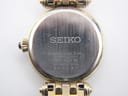 Detailed view of the Seiko watch's stainless steel case back with model and serial numbers.