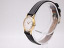 Angled side view of the vintage Seiko watch, highlighting the slender gold-plated case and crown.