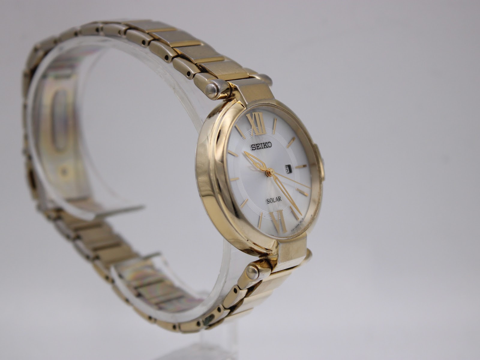Close-up of the watch's stainless steel case back, engraved with model and serial numbers.