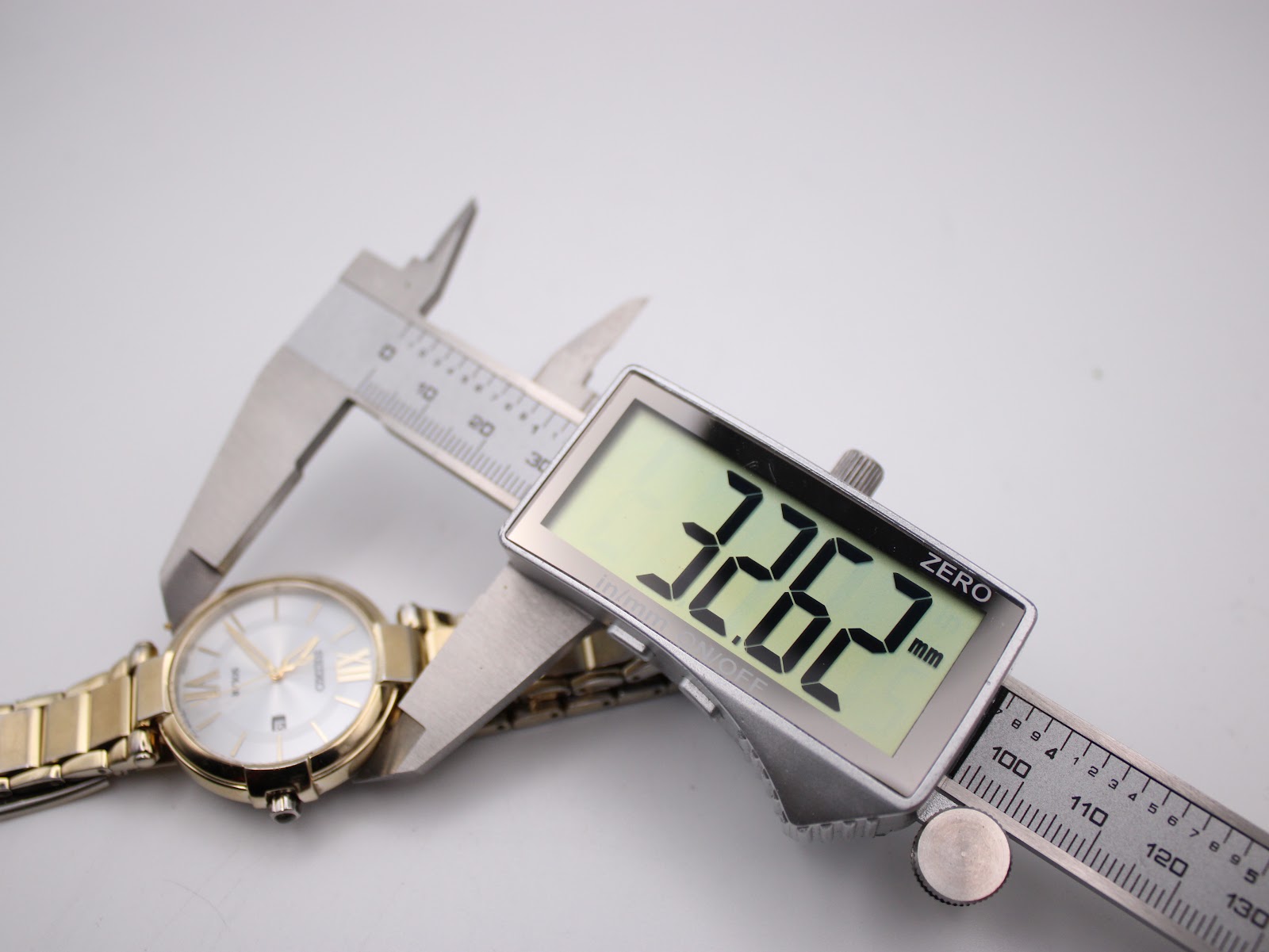 Close-up showing the watch's case diameter accurately measured at 32.62mm with digital callipers.