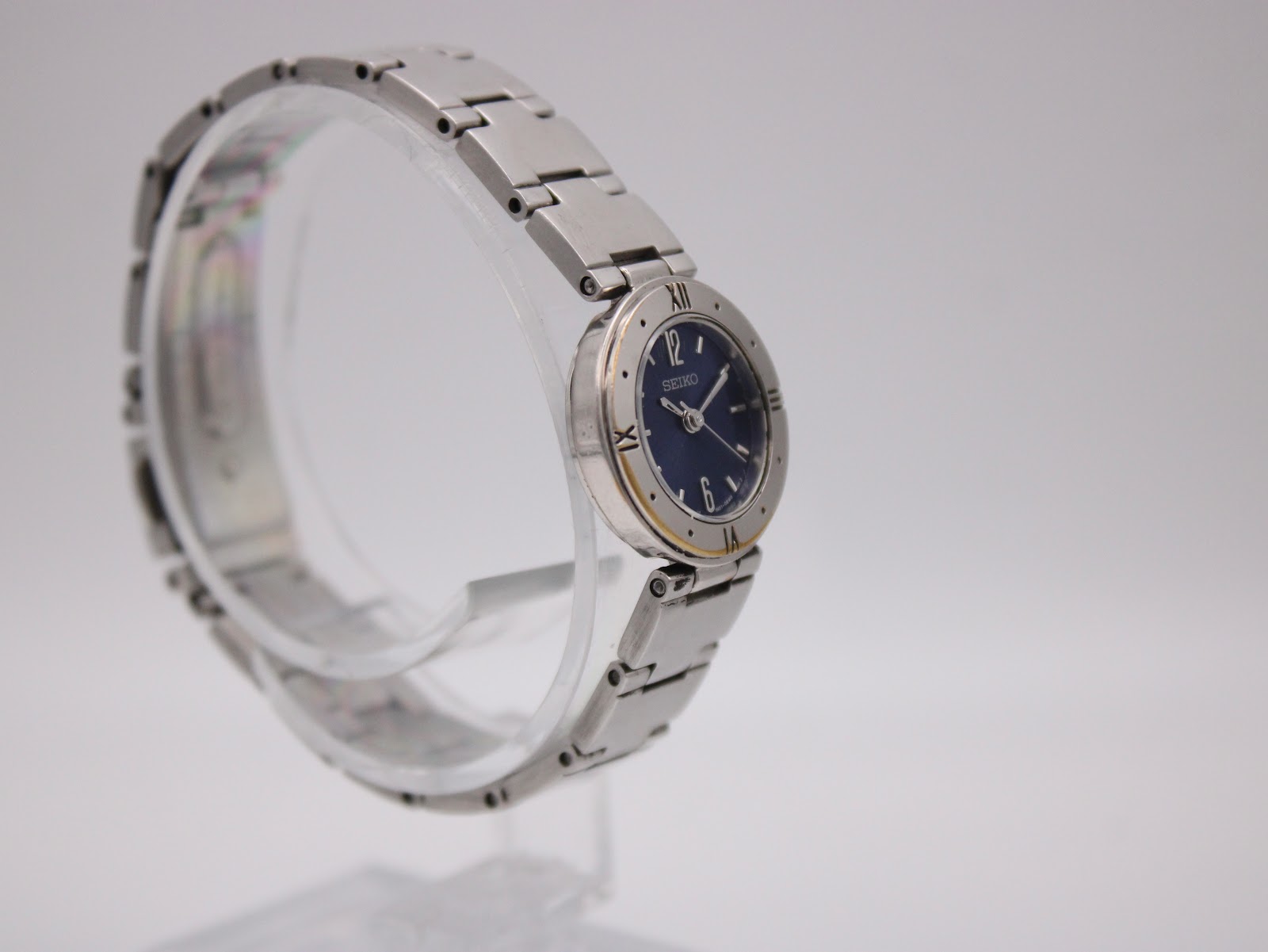 Another angled side view of the Seiko ladies' watch, highlighting the bezel with Roman numeral markings.