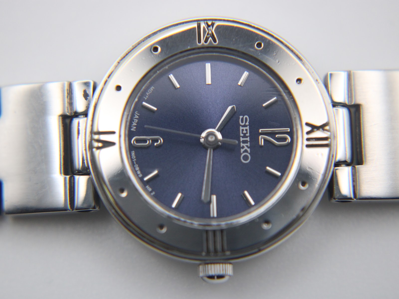 Close-up front view of the Seiko navy blue dial, showing the applied baton indices and Seiko logo.