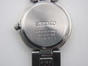 Close-up of the Seiko watch case back, showing 'Water Resistant', '1N01-0AT0', and serial number '396054'.