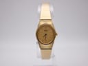 Front view of gold Seiko quartz watch with oval case and integrated mesh bracelet on a white background.