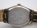 Close-up of the stainless steel case back of the Seiko watch, showing brand, model '2020-6470', and serial '584387' engravings.