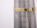 The gold mesh bracelet of the Seiko watch wrapped around a wrist sizing gauge, indicating a size of approximately 15.5cm.