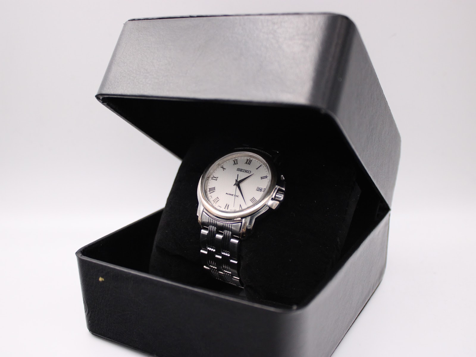 The Seiko Kinetic watch presented within a plain black display box.