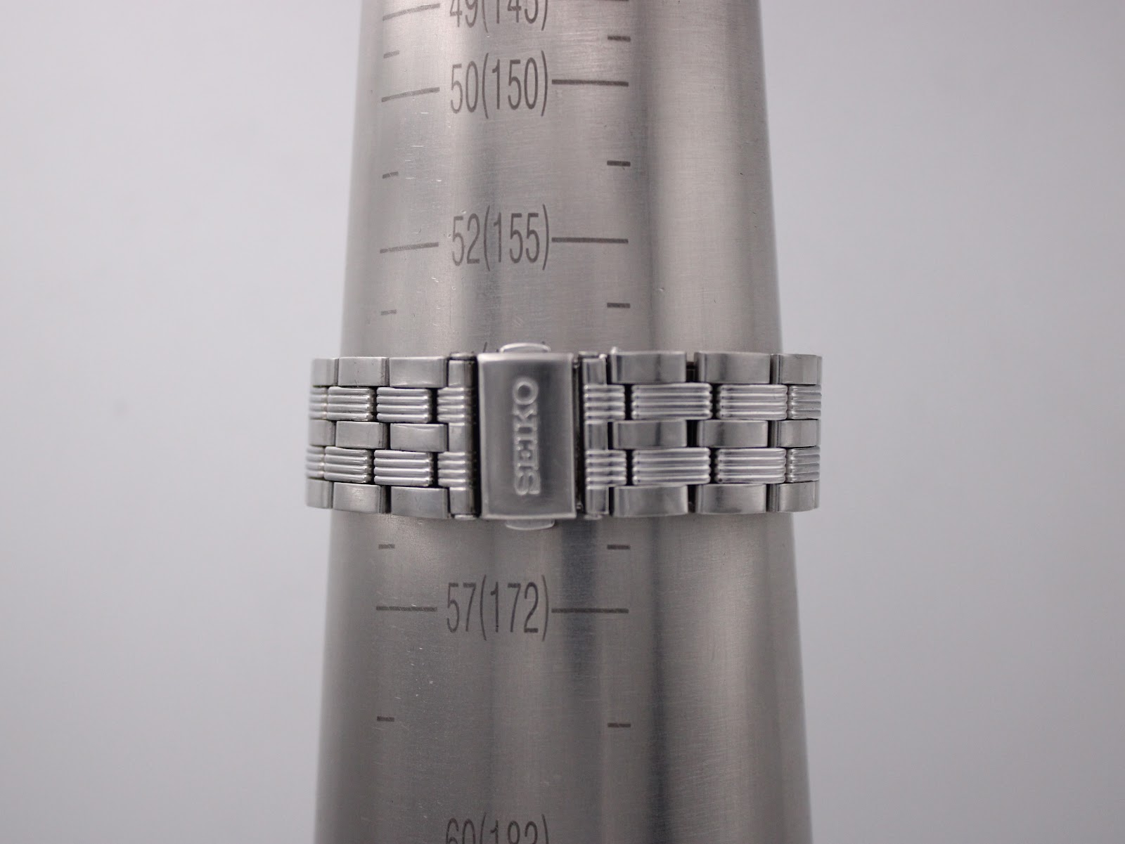 Rear view of the Seiko bracelet clasp on a wrist sizing cone, showing a wrist circumference of 172mm.