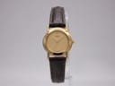 Front face of Seiko 1N01-0A10 gold dial watch on a stand.