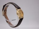 Close-up of the signed Seiko buckle on the dark brown leather strap.