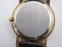Detailed view of the patterned gold dial, Seiko logo, and hands.
