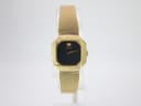 Front face of vintage Seiko 2320-5100 gold tone watch with black dial.