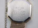 Detailed view of the Seiko watch case back with serial number and model information.