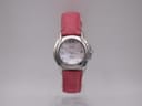 Front view of Seiko Vivace ladies' watch with mother of pearl dial and pink leather strap, presented on a clear stand.