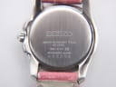 Close-up of the Seiko Vivace watch case back, displaying engraved model number 7N82-0CE0, serial number, and water resistance.