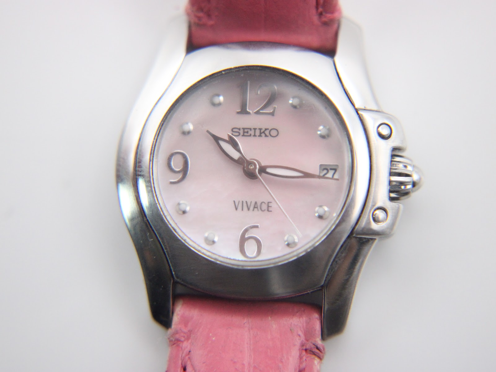 Detailed close-up of the Seiko Vivace mother of pearl dial, featuring Arabic numerals at 6, 9, 12, dot indices, and a date window at 3 o'clock.