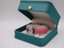 Seiko Vivace watch with pink strap displayed inside an open, teal coloured presentation box.