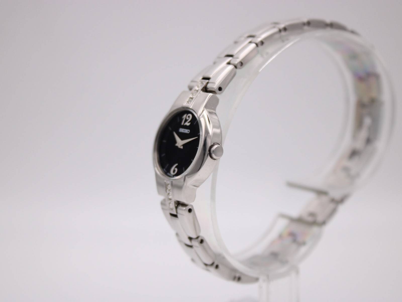 Side profile view of the small Seiko quartz watch, showing its silver-tone case and integrated bracelet.