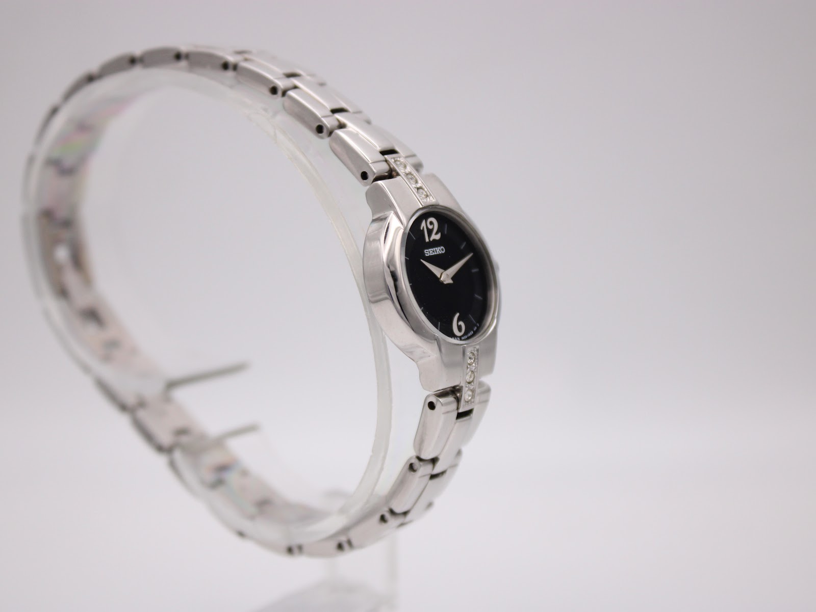 Close-up of the Seiko watch dial, highlighting the applied numerals and crystal-set lugs.