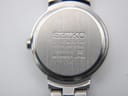 Reverse view of the Seiko watch case back, showing serial number and model details.