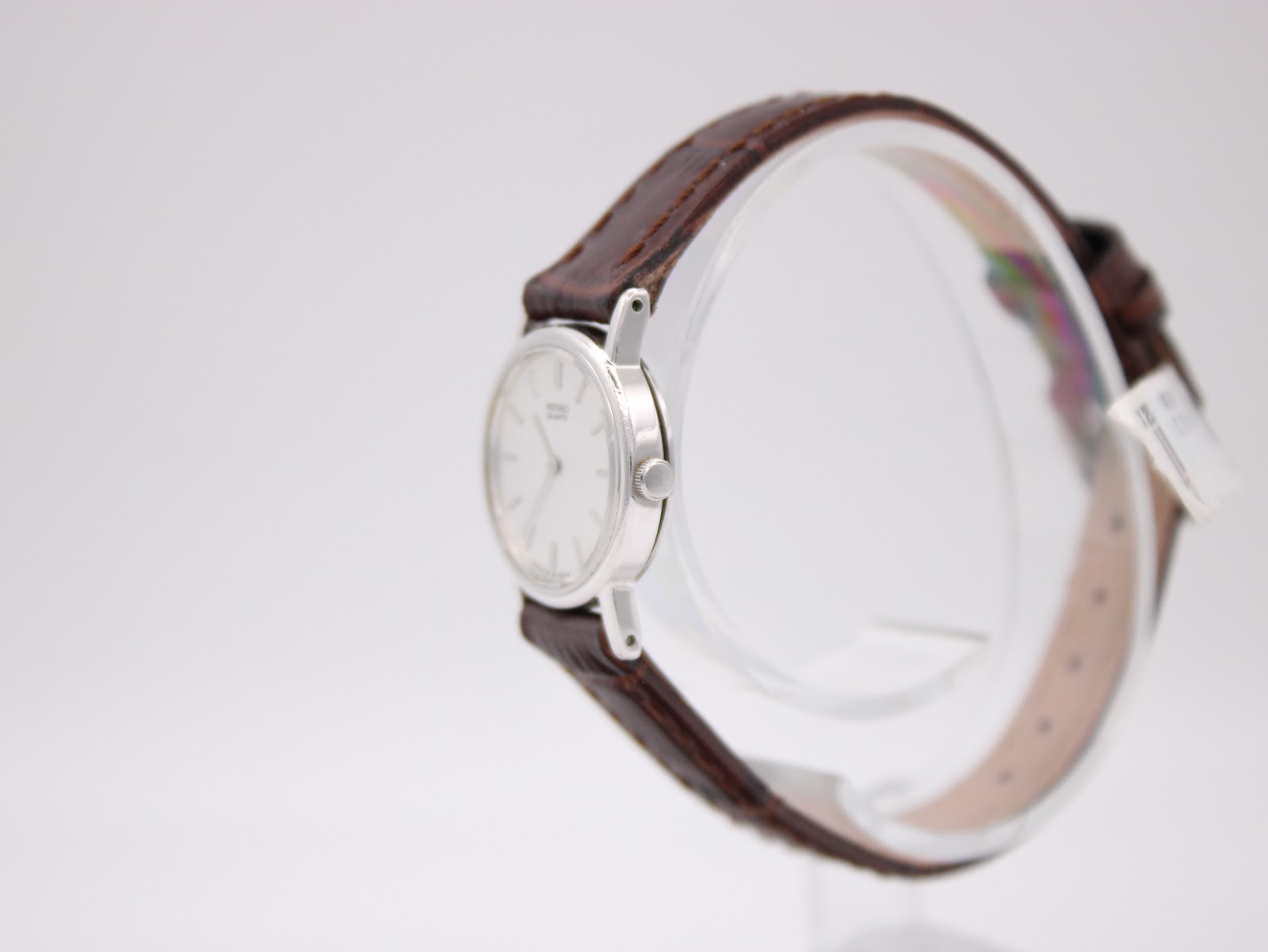 Side profile of the slim silver-tone Seiko watch case and crown.
