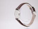 Side profile of the slim silver-tone Seiko watch case and crown.