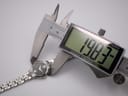 Digital caliper measuring the case diameter of the Seiko watch, showing 19.83mm.