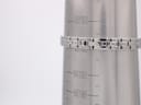Close-up of the stainless steel bracelet on a wrist sizing cone, indicating a wrist circumference of approximately 186.5mm.