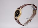 Side profile of the vintage Seiko quartz watch, highlighting the gold-tone case curve and crown.