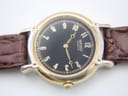 Full view of the watch on its dark brown crocodile-pattern leather strap with gold-tone buckle.